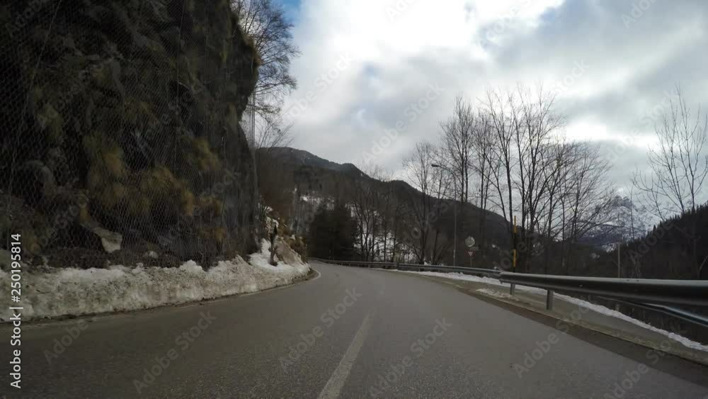 driving car in winter on countryside mountain alps curvy ice covered road italian alps driving car in winter on countryside mountain alps curvy ice covered road italian alps