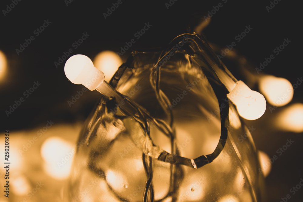 Yellow Christmas lighting garland in the darkness. Yellow Christmas lighting garland in the darkness.