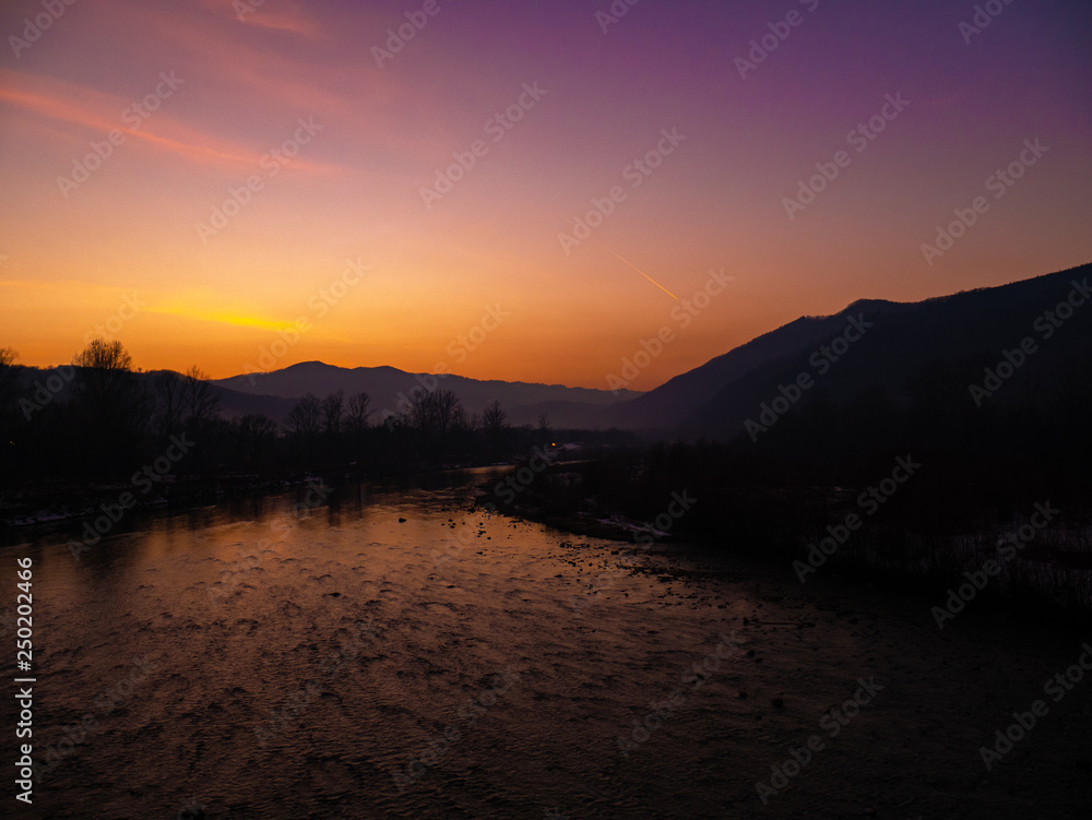 Naklejka premium Beautiful landscape stones in mountain lake, reflection, blue sky and yellow sunlight in sunrise. Ukraine. Amazing scene