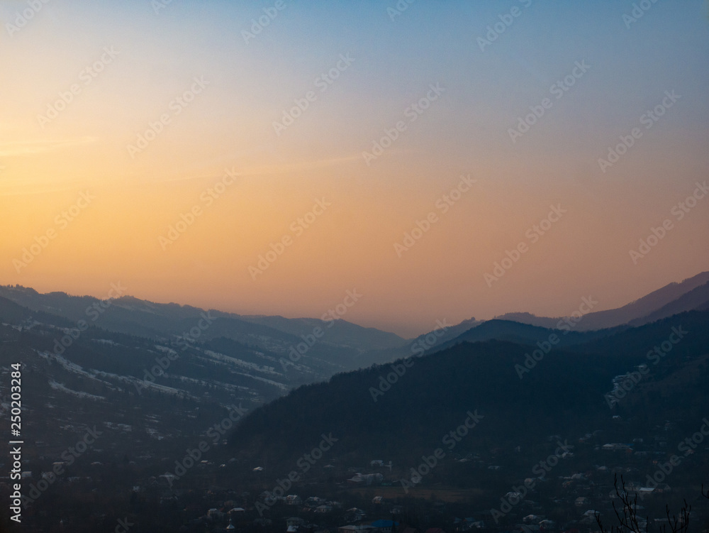 Amazing and beautiful view of the mountains in the rays of the setting sun
