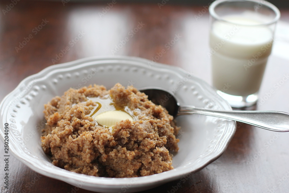 A plate of traditional Finnish talkkuna porridge and a glass of milk A plate of traditional Finnish talkkuna porridge and a glass of milk