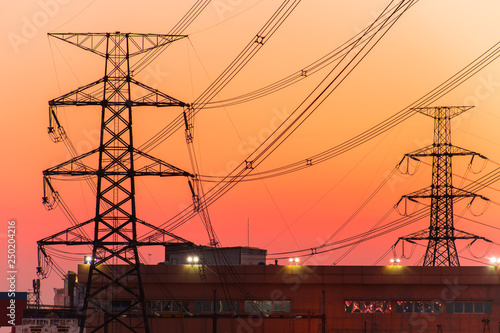 High voltage transmission lines. High voltage tower background at dusk.