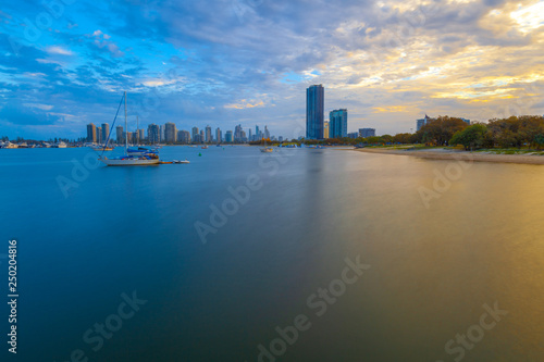 Moored sailboats and skyscrapers at sunset - long exposure. Gold Coast, Queensland, Australia
