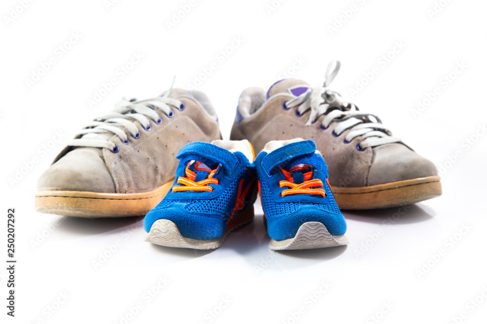 Big and small sneakers shoes on white background. Father's day composition Big and small sneakers shoes on white background. Father's day composition