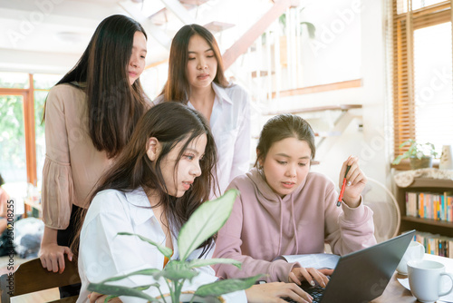 Group of business women with laptop discussing