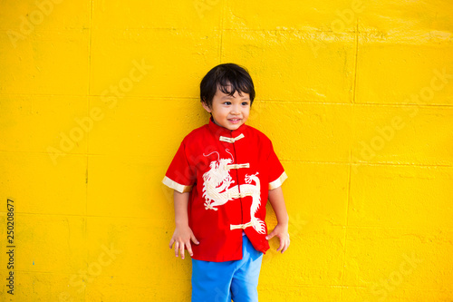 Happy Asian baby boy in red Chinese suit