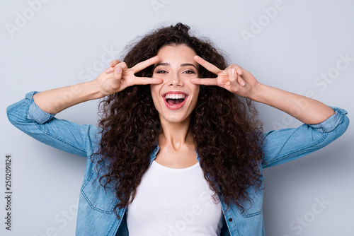 Portrait of her she nice cute charming winsome attractive lovely cheerful optimistic funny toothy wavy-haired girl showing double v-sign near eyes isolated over gray pastel background
