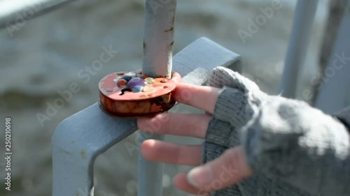 Love lock locked in on the rusty metal railing of the bank of Daugava river in Riga