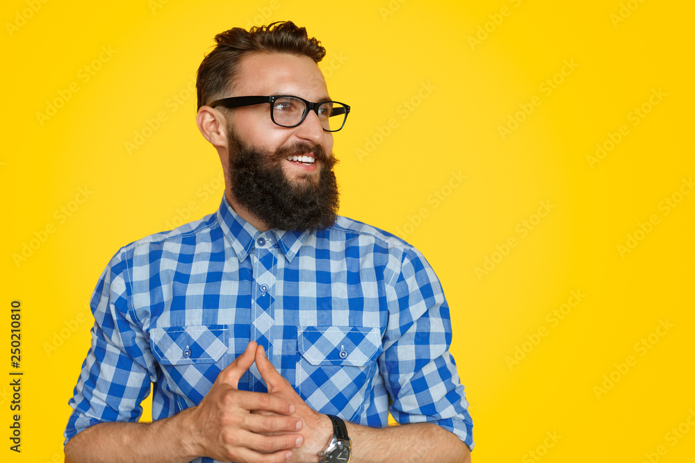 Stylish guy clasping hand and looking away Stylish guy clasping hand and looking away