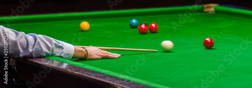 playing snooker - man aiming the cue ball photo