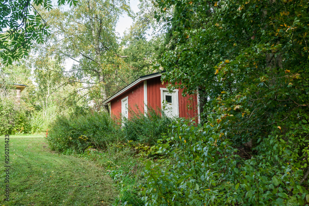 KOUVOLA, FINLAND - SEPTEMBER 20, 2018: Beautiful red old wooden house on the territory of Anjala manor. KOUVOLA, FINLAND - SEPTEMBER 20, 2018: Beautiful red old wooden house on the territory of Anjala manor.