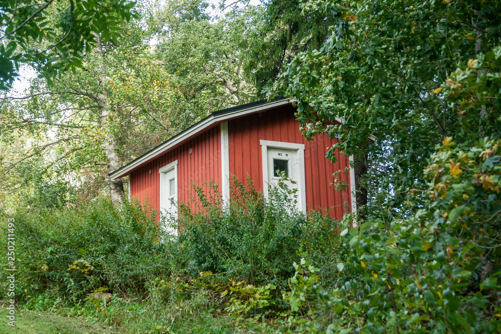 KOUVOLA, FINLAND - SEPTEMBER 20, 2018: Beautiful red old wooden house on the territory of Anjala manor. KOUVOLA, FINLAND - SEPTEMBER 20, 2018: Beautiful red old wooden house on the territory of Anjala manor.