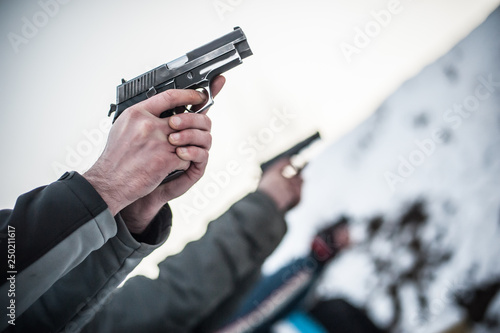 Canvas Print Close-up view of shooter practice handgun shooting in row group