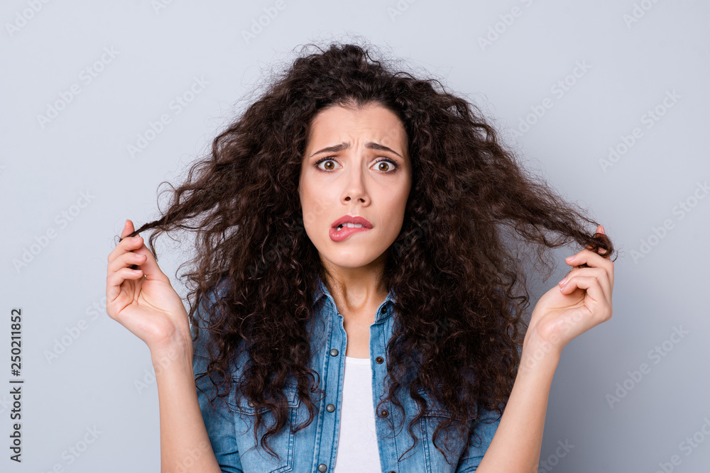 Close-up portrait of her she nice-looking cute charming attractive worried wavy-haired girl holding soft wealth curls thinking about solution isolated over gray pastel background Close-up portrait of her she nice-looking cute charming attractive worried wavy-haired girl holding soft wealth curls thinking about solution isolated over gray pastel background