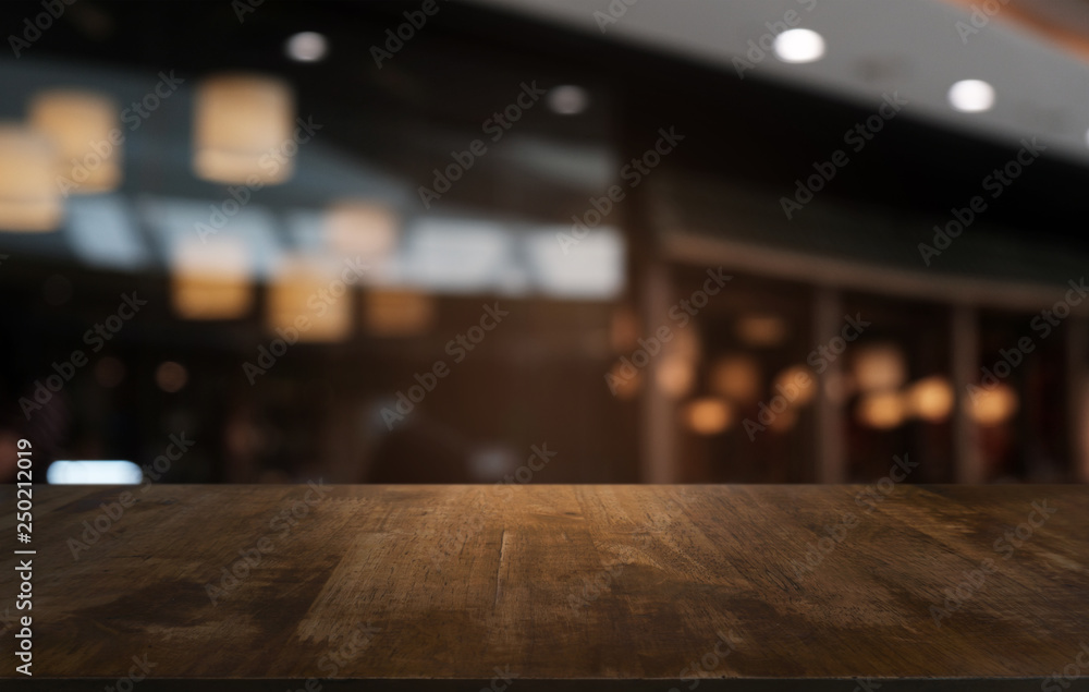 Empty dark wooden table in front of abstract blurred bokeh background of restaurant . can be used for display or montage your products.Mock up for space. Empty dark wooden table in front of abstract blurred bokeh background of restaurant . can be used for display or montage your products.Mock up for space.