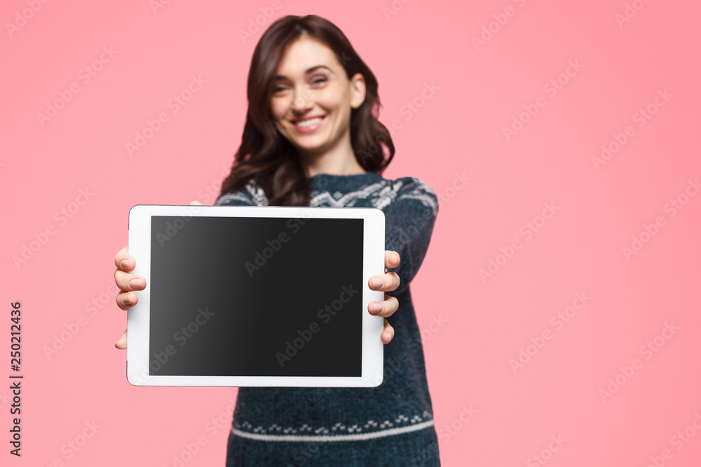 Glad female showing tablet with black screen Glad female showing tablet with black screen