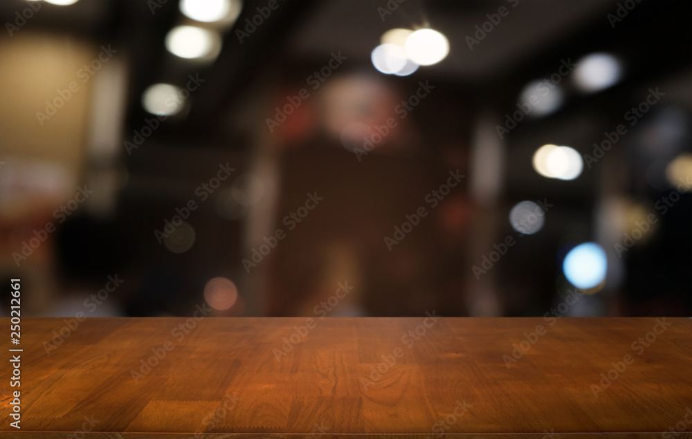 Empty dark wooden table in front of abstract blurred bokeh background of restaurant . can be used for display or montage your products.Mock up for space.