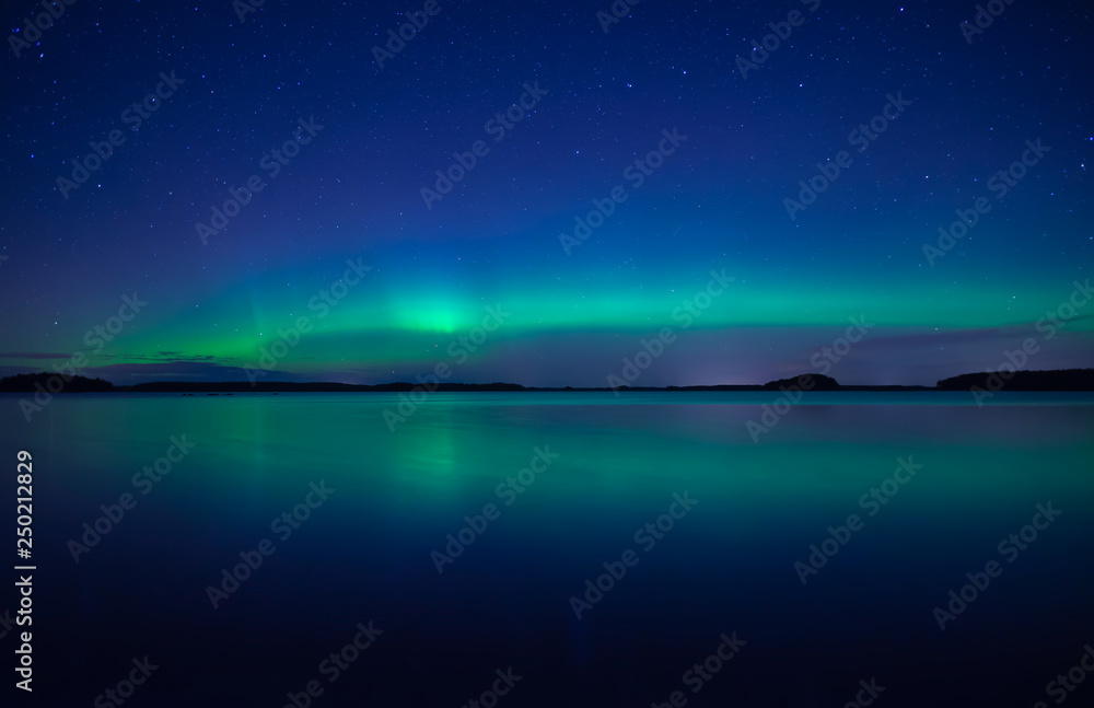 Northern lights background in Farnebofjarden national park in Sweden.