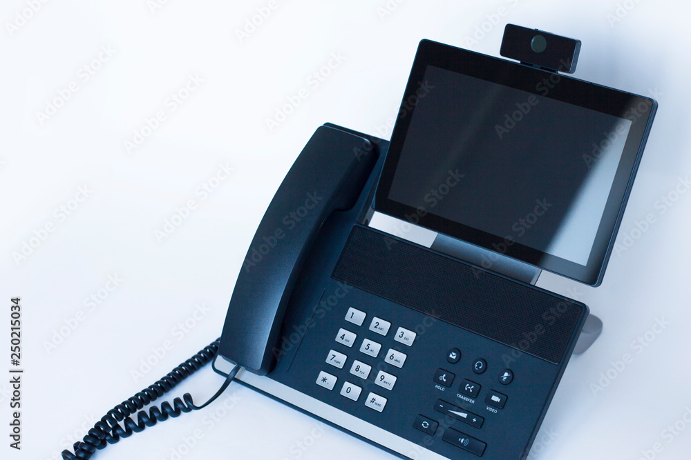 Ip telephony concept. Modern ip phones, sip terminals, conference phones and cameras for video meetings on office background. Top view. Ip telephony concept. Modern ip phones, sip terminals, conference phones and cameras for video meetings on office background. Top view.