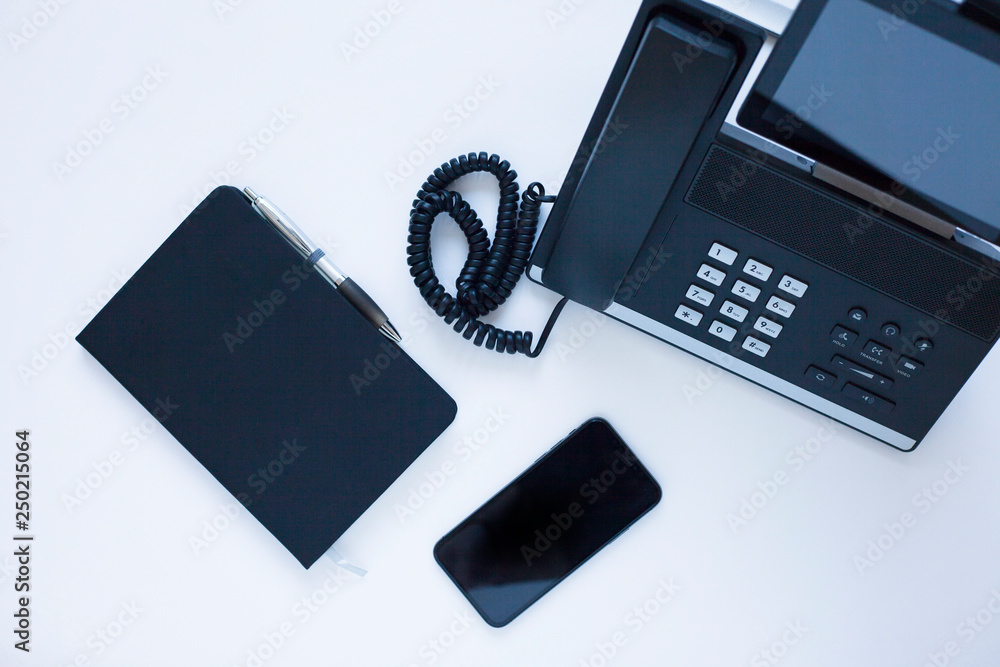 Ip telephony concept. Modern ip phones, sip terminals, conference phones and cameras for video meetings on office background. Top view. Ip telephony concept. Modern ip phones, sip terminals, conference phones and cameras for video meetings on office background. Top view.