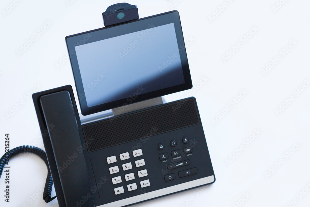 Ip telephony concept. Modern ip phones, sip terminals, conference phones and cameras for video meetings on office background. Top view. Ip telephony concept. Modern ip phones, sip terminals, conference phones and cameras for video meetings on office background. Top view.