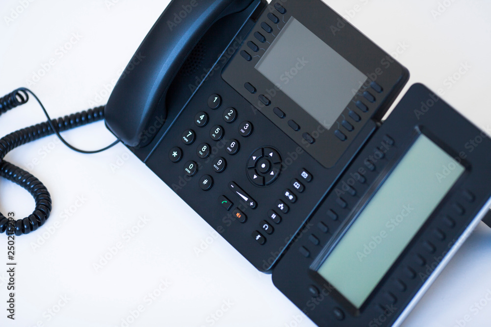 Ip telephony concept. Modern ip phones, sip terminals, conference phones and cameras for video meetings on office background. Top view. Ip telephony concept. Modern ip phones, sip terminals, conference phones and cameras for video meetings on office background. Top view.