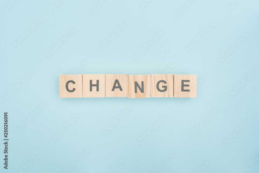 top view of change lettering made of wooden blocks on blue background top view of change lettering made of wooden blocks on blue background