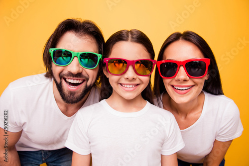 Close-up portrait of nice cute lovely attractive cheerful people having fun day dream wearing colorful modern eyeglasses eyewear trend isolated on shine vivid pastel yellow background