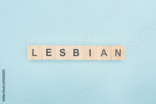 top view of lesbian lettering made of wooden cubes on blue background