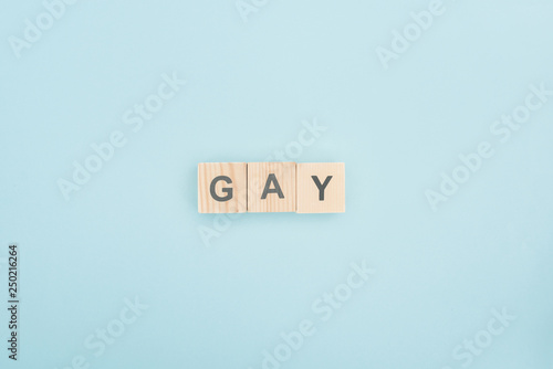 top view of gay lettering made of wooden cubes on blue background © LIGHTFIELD STUDIOS