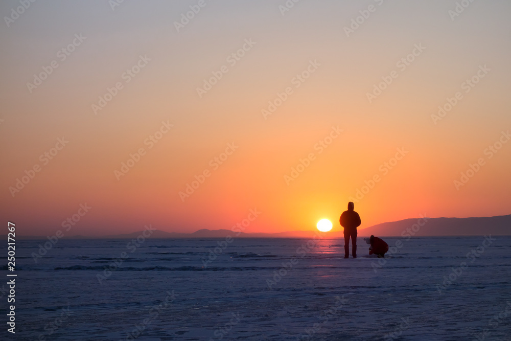People figures at sunset in winter