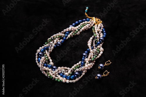 A multi-colored beads from pearls with earrings darkly blue
