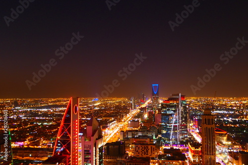 Panorama view to the skyline of Riyadh by night, with skyscrapers in the background and busy traffic on the streets of Riyadh, the capital of Saudi Arabia photo