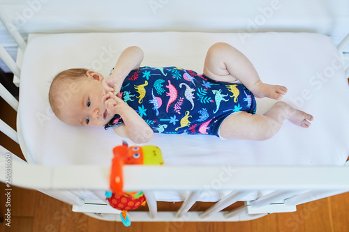 Baby girl in co-sleeper crib photo