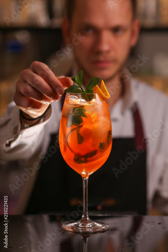 Barmen is making Aperol Spritz cocktail.  Alcohol cocktail on black background surface