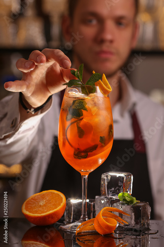 Barmen is making Aperol Spritz cocktail.  Alcohol cocktail on black background surface