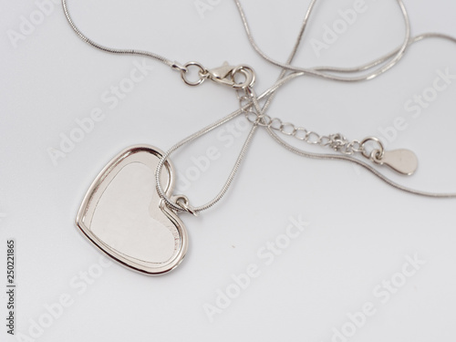 silver trinket with a place for a photo. present. on a white background.