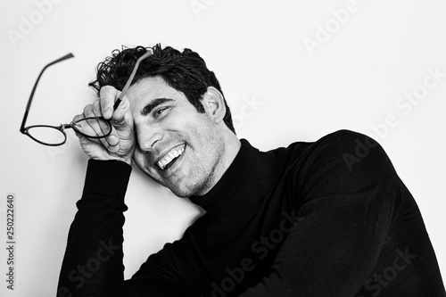 Smiling guy with glasses in studio