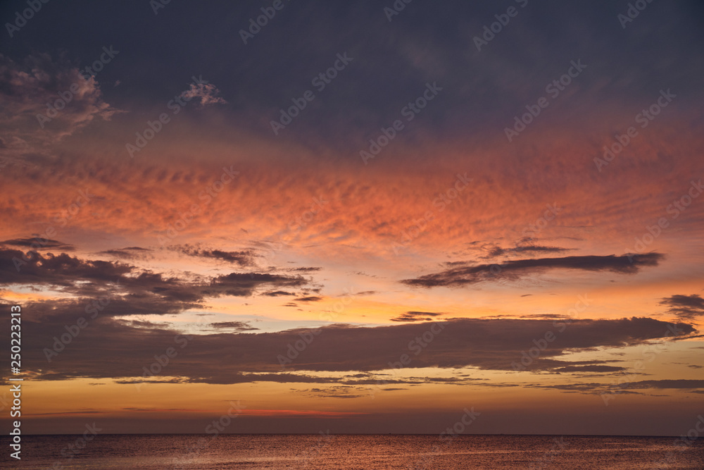 Beautiful sunset on the sea and sky with clouds.