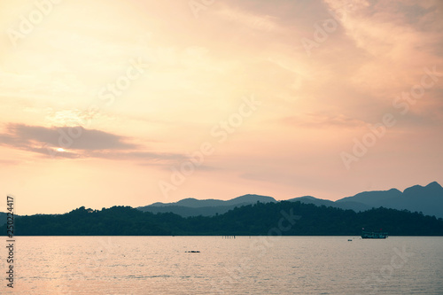 Boat at sea against mountains at sunset  tropical landscape of Thailand