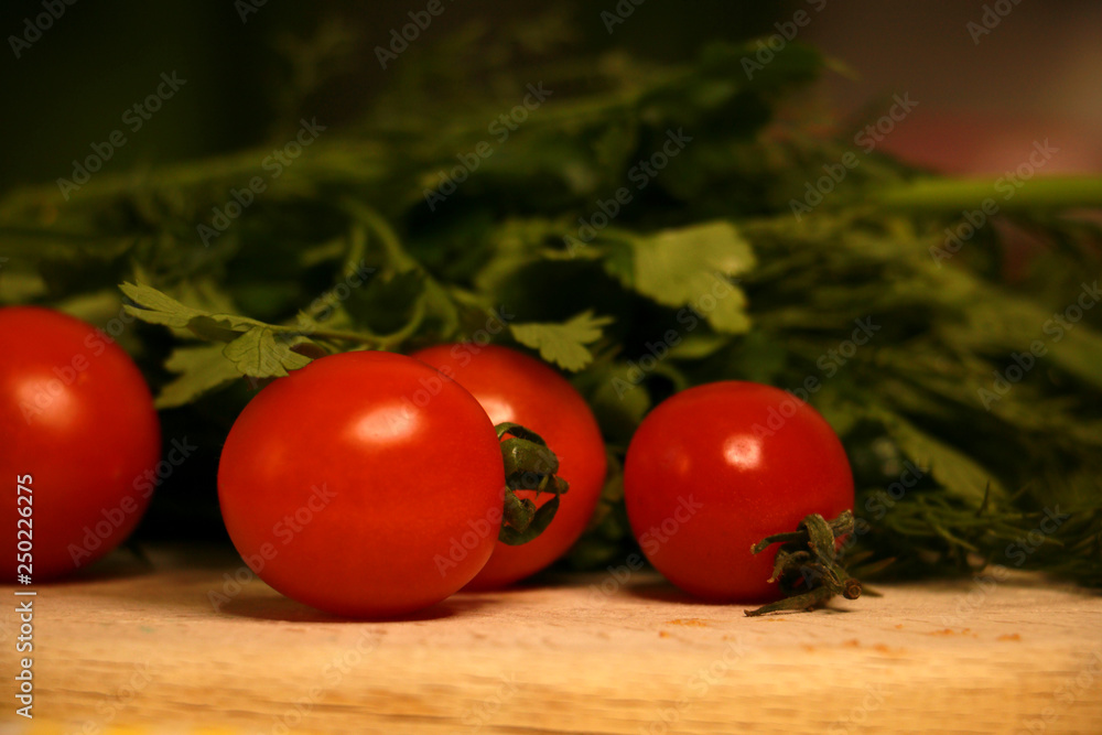 fresh red cherry tomatoes with green on the table fresh red cherry tomatoes with green on the table