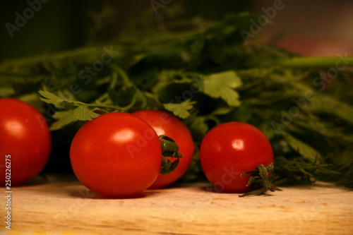 fresh red cherry tomatoes with green on the table