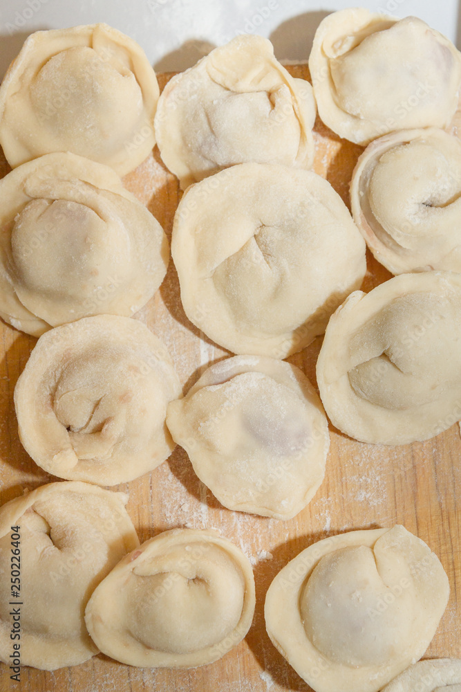 Raw and fresh is stuck on the dumplings are on the Board Raw and fresh is stuck on the dumplings are on the Board