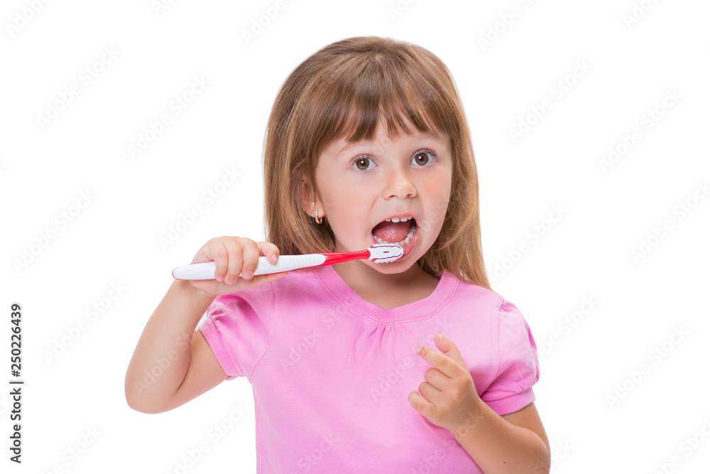 Close-up portrait Cute little girl 3 year old in pink t-shirt brushing her teeth isolated on white background Close-up portrait Cute little girl 3 year old in pink t-shirt brushing her teeth isolated on white background