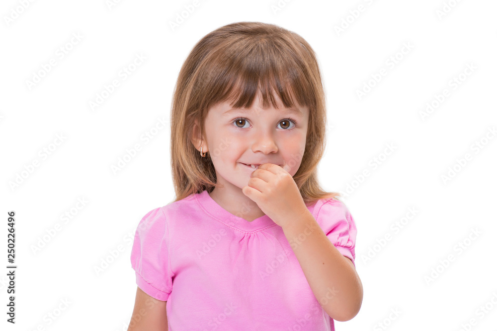 Cute little girl 3 year old in pink t-shirt holds fingers in mouth or bites nails isolated on white background. Bad childhood habits Cute little girl 3 year old in pink t-shirt holds fingers in mouth or bites nails isolated on white background. Bad childhood habits