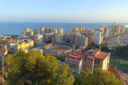 aerial view of the cityscape with the ancient bullring and the mediterranean sea