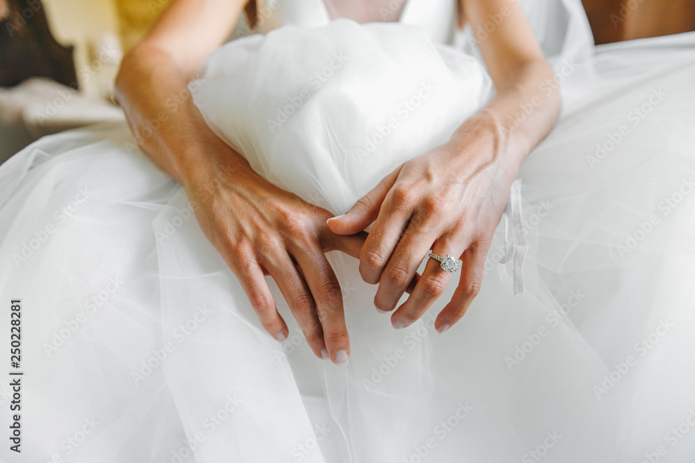 Tender hands of pretty bride lying on her dress Tender hands of pretty bride lying on her dress