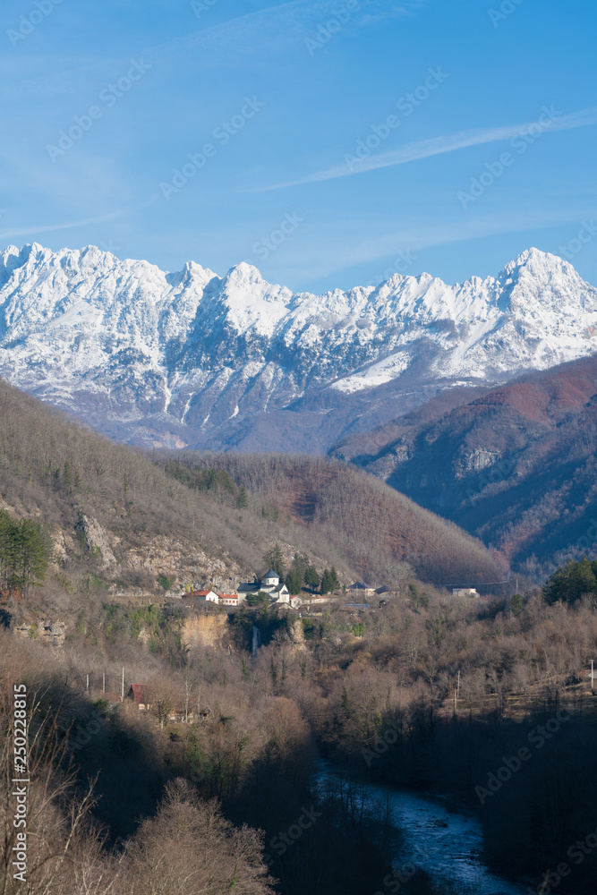 Moraca monastery on a background of snow-capped mountains