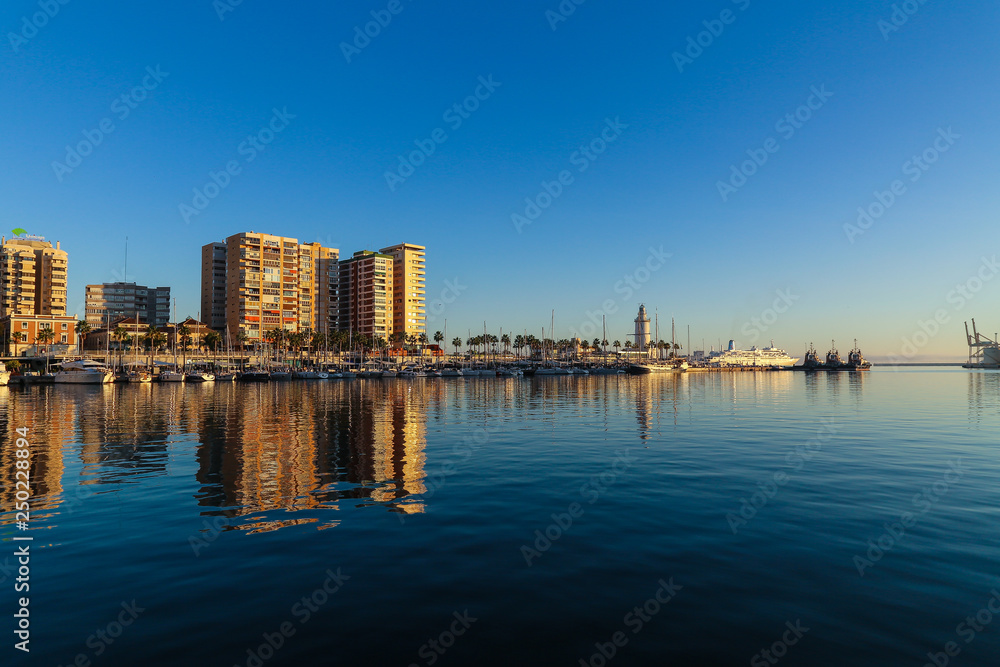Skyline at the port of malaga with calm water