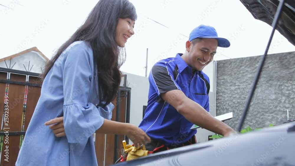techinician help customer fixing his car in the house techinician help customer fixing his car in the house